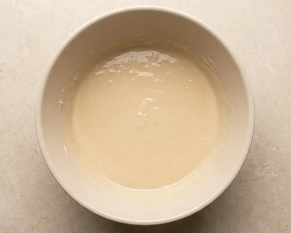 Feuchte Zutaten für gesunden Karottenkuchen in Schüssel von oben fotografiert