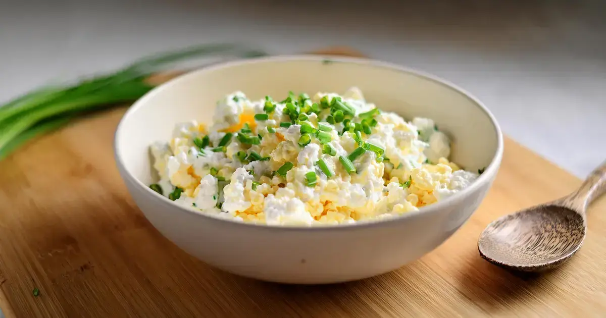 Cremiger High-Protein Eiersalat mit körnigem Frischkäse und Schnittlauch, serviert in einer weißen Schale.